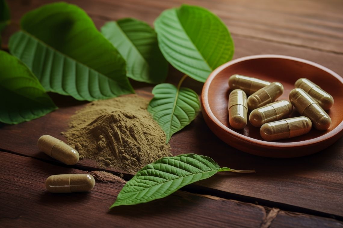Close-up of green Maeng Da kratom powder in a wooden bowl